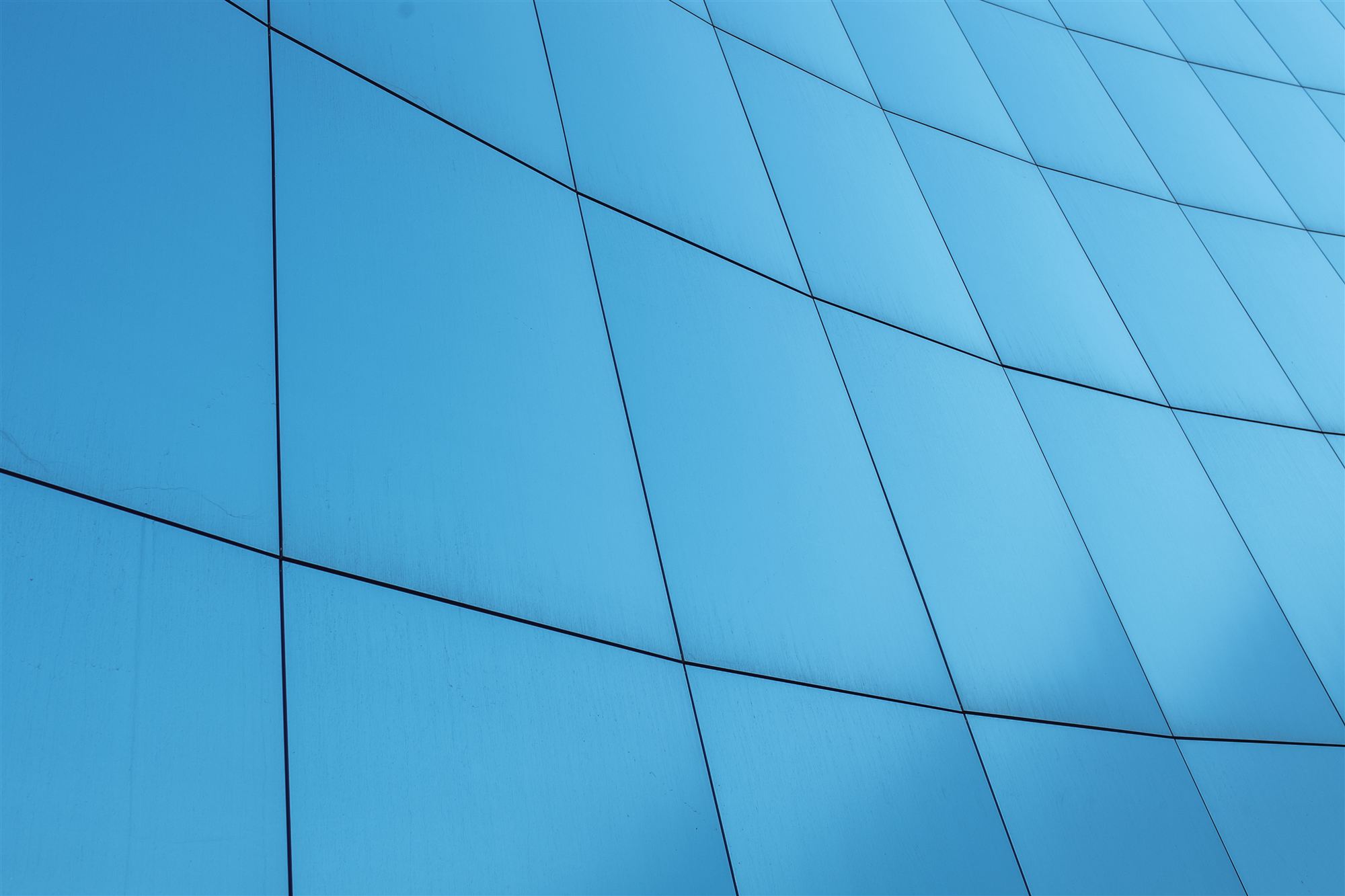 Curved blue glass building facade